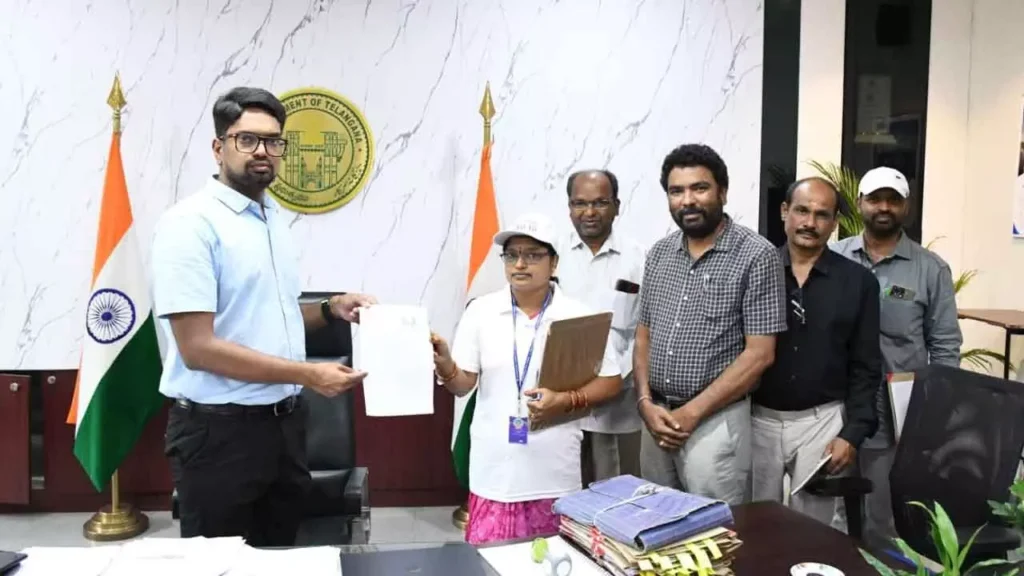 BLO Lavanya handing over the voter enumeration form to District Collector Adarsh Surabhi as part of the Special Intensive Revision. n9